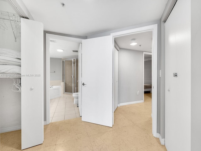 16699 Collins Ave Unit 2906, Sunny Isles Beach, FL 33160 - unfurnished bedroom with baseboards, light tile patterned floors, and ensuite bathroom