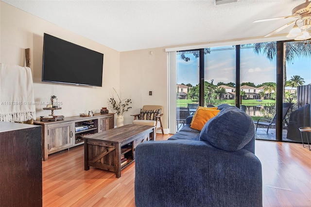 10630 NW 14th St Unit 115, Plantation, FL 33322 - living room featuring a ceiling fan and light wood finished floors