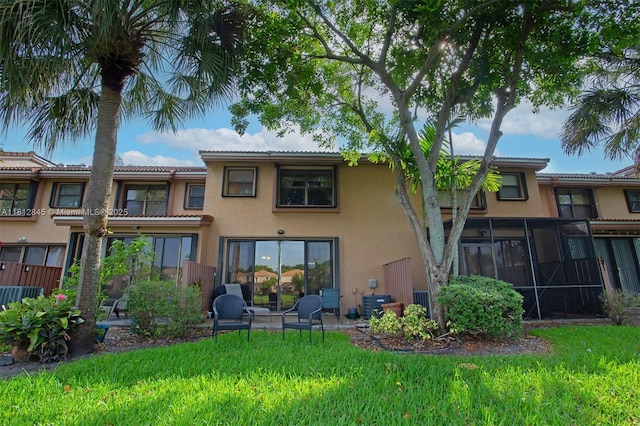10630 NW 14th St Unit 115, Plantation, FL 33322 - back of house featuring stucco siding, a yard, and a tile roof