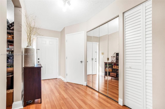 10630 NW 14th St Unit 115, Plantation, FL 33322 - corridor featuring light wood-style flooring, a textured ceiling, and baseboards