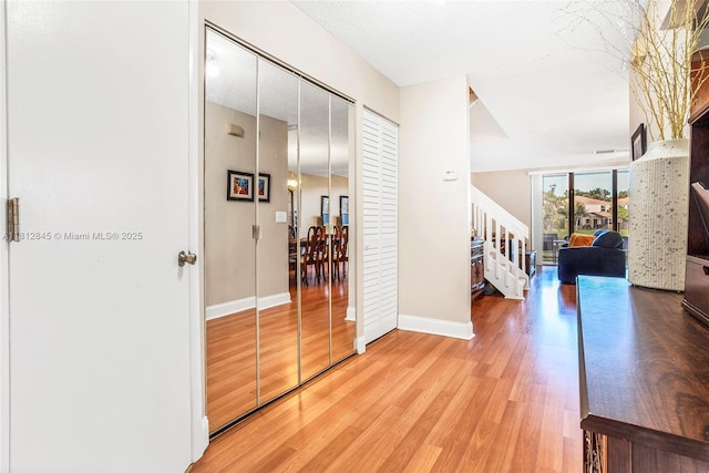 10630 NW 14th St Unit 115, Plantation, FL 33322 - hallway with stairway, wood finished floors, and baseboards