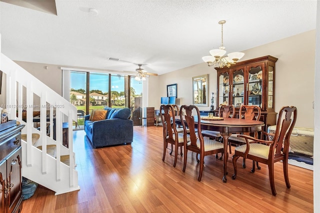 10630 NW 14th St Unit 115, Plantation, FL 33322 - dining room with stairs, light wood-style floors, a chandelier, and ceiling fan