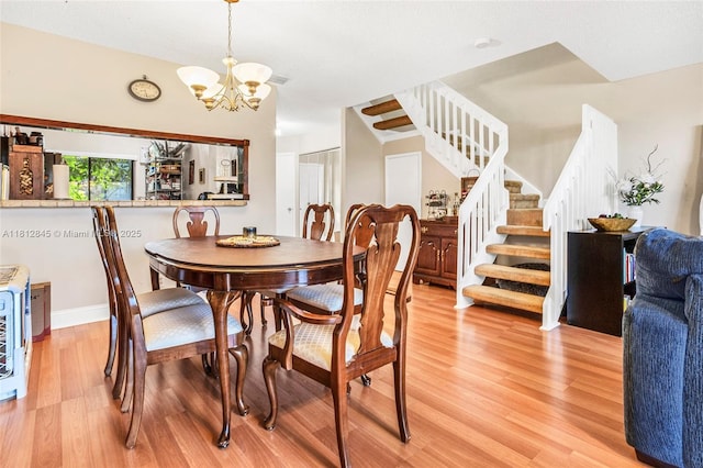 10630 NW 14th St Unit 115, Plantation, FL 33322 - dining space with stairway, light wood finished floors, a chandelier, and baseboards