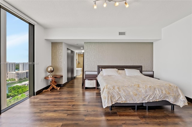16275 Collins Ave Unit 2101, Sunny Isles Beach, FL 33160 - bedroom featuring wood finished floors, a textured ceiling, and baseboards