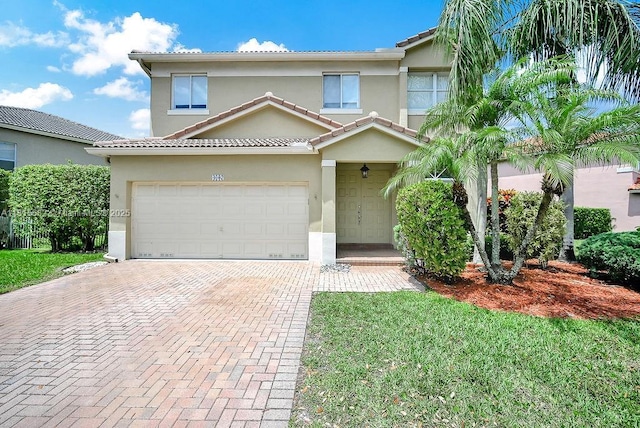 4007 Turquoise Trl, Weston, FL 33331 - view of front of property featuring stucco siding, decorative driveway, a tiled roof, and an attached garage