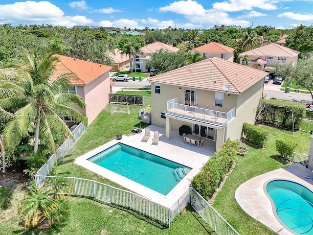 4007 Turquoise Trl, Weston, FL 33331 - rear view of property featuring a balcony, stucco siding, a tiled roof, and a patio area