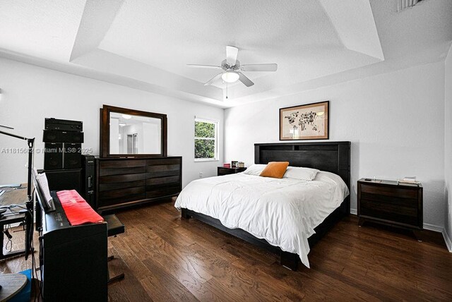 4007 Turquoise Trl, Weston, FL 33331 - bedroom featuring a tray ceiling, wood finished floors, an office area, a ceiling fan, and baseboards