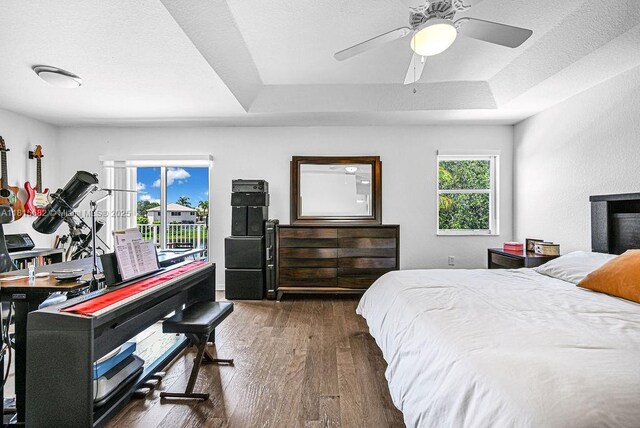 4007 Turquoise Trl, Weston, FL 33331 - bedroom with wood finished floors, a tray ceiling, and a ceiling fan