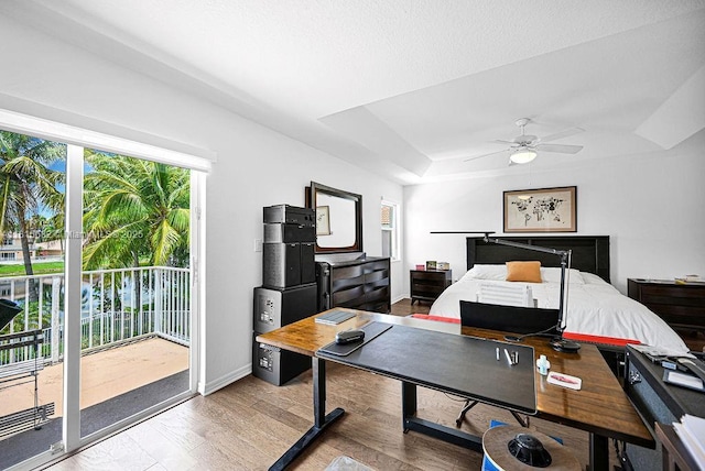 4007 Turquoise Trl, Weston, FL 33331 - bedroom with access to exterior, a raised ceiling, a desk, and wood finished floors