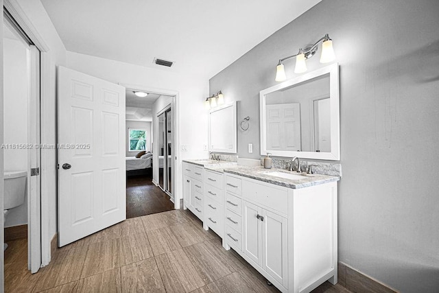 4007 Turquoise Trl, Weston, FL 33331 - bathroom featuring connected bathroom, double vanity, toilet, and baseboards