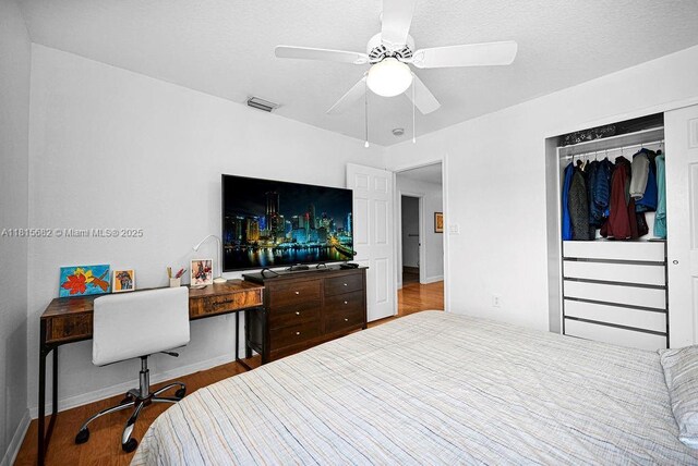4007 Turquoise Trl, Weston, FL 33331 - bedroom with wood finished floors, a closet, an office area, a ceiling fan, and baseboards