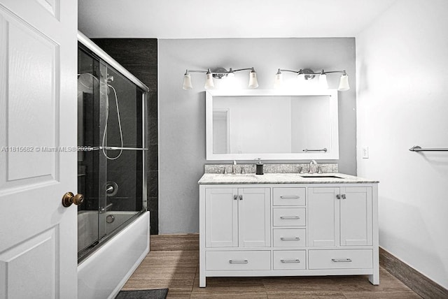 4007 Turquoise Trl, Weston, FL 33331 - full bath featuring double vanity, combined bath / shower with glass door, wood finished floors, and baseboards
