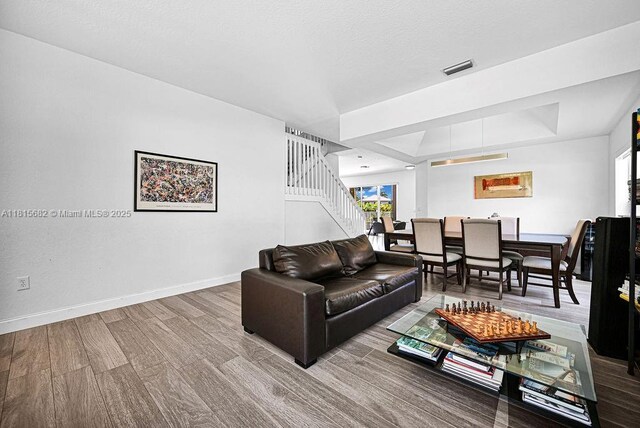 4007 Turquoise Trl, Weston, FL 33331 - living room featuring healthy amount of natural light, baseboards, stairs, and wood finished floors