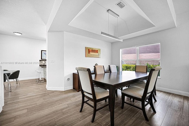 4007 Turquoise Trl, Weston, FL 33331 - dining room featuring wood finished floors, a raised ceiling, and baseboards