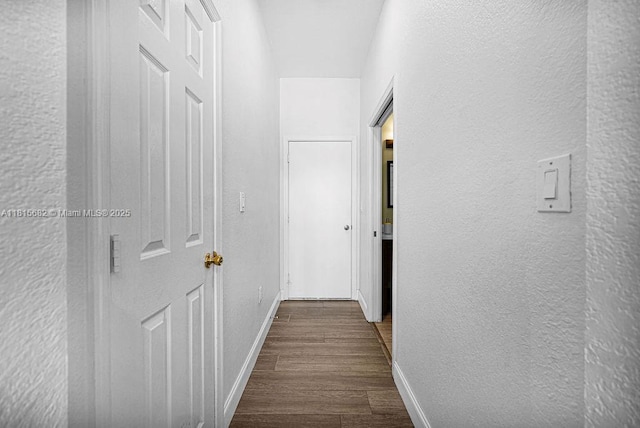 4007 Turquoise Trl, Weston, FL 33331 - hallway featuring a textured wall, dark wood-type flooring, and baseboards