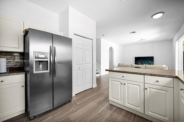 4007 Turquoise Trl, Weston, FL 33331 - kitchen with stainless steel fridge with ice dispenser, arched walkways, white cabinets, and dark wood-style flooring