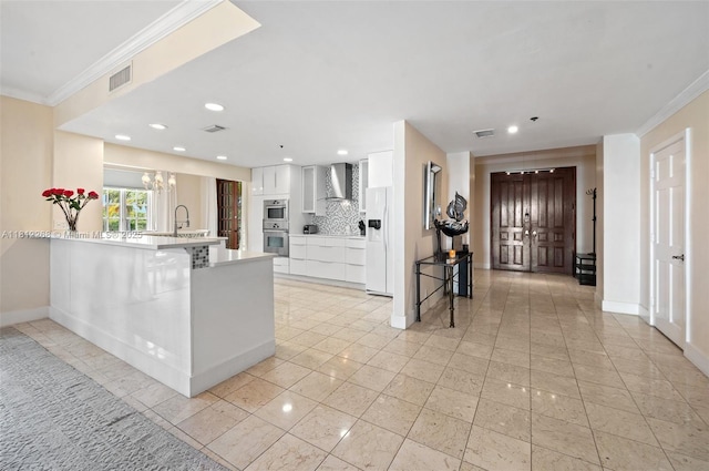 2124 Fisher Island Dr Unit 2124, Miami Beach, FL 33109 - kitchen featuring white refrigerator with ice dispenser, crown molding, a peninsula, white cabinets, and a breakfast bar area