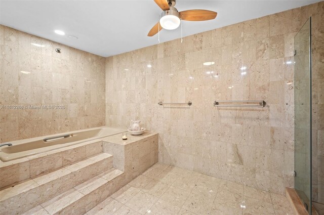 2124 Fisher Island Dr Unit 2124, Miami Beach, FL 33109 - full bathroom with a garden tub, a ceiling fan, and tile walls