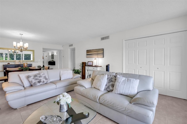 3301 S Palm Aire Dr Unit 106, Pompano Beach, FL 33069 - living area with a chandelier, light tile patterned floors, and a textured ceiling