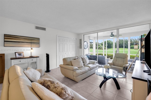 3301 S Palm Aire Dr Unit 106, Pompano Beach, FL 33069 - living room featuring light tile patterned floors, ceiling fan, and a wall of windows