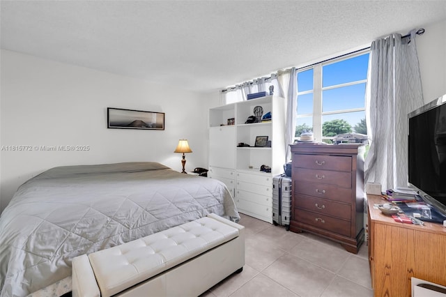 3301 S Palm Aire Dr Unit 106, Pompano Beach, FL 33069 - bedroom with light tile patterned floors and a textured ceiling