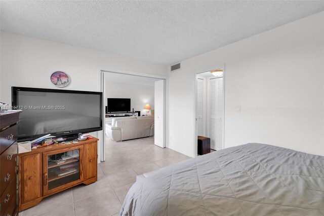 3301 S Palm Aire Dr Unit 106, Pompano Beach, FL 33069 - bedroom with light tile patterned flooring and a textured ceiling
