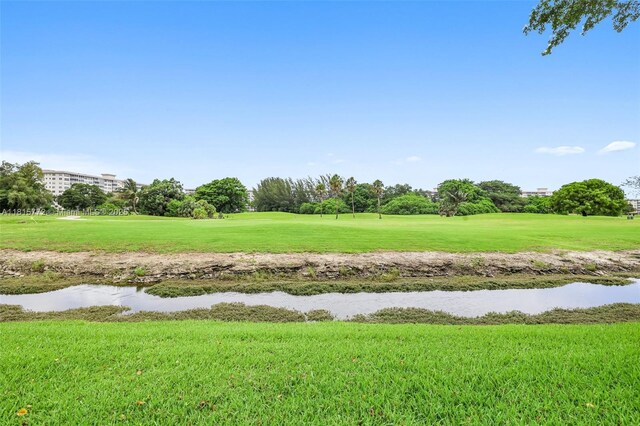 3301 S Palm Aire Dr Unit 106, Pompano Beach, FL 33069 - view of property's community with view of golf course, a lawn, and a water view