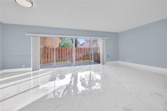 8211 NW 8th St Unit 2, Plantation, FL 33324 - empty room featuring marble tiled floors and baseboards