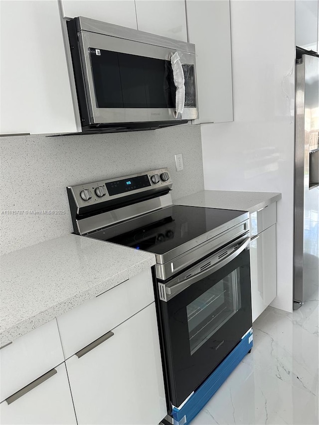 8211 NW 8th St Unit 2, Plantation, FL 33324 - kitchen with stainless steel appliances, modern cabinets, and white cabinetry