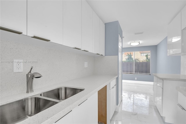 8211 NW 8th St Unit 2, Plantation, FL 33324 - kitchen featuring a sink, light marble finish flooring, white cabinetry, decorative backsplash, and modern cabinets