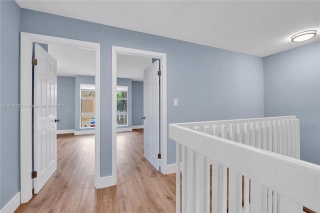 8211 NW 8th St Unit 2, Plantation, FL 33324 - hallway with light wood-style flooring, baseboards, and an upstairs landing