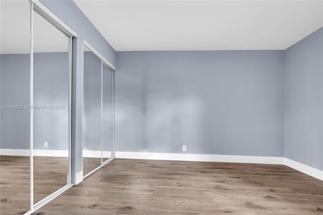 8211 NW 8th St Unit 2, Plantation, FL 33324 - unfurnished bedroom featuring wood finished floors, baseboards, and multiple closets