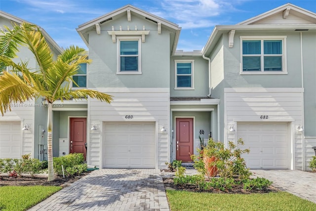 680 SE Lake Falls St, Port St Lucie, FL 34984 - view of front of home featuring an attached garage and decorative driveway