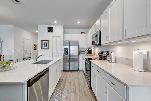 680 SE Lake Falls St, Port St Lucie, FL 34984 - kitchen with stainless steel appliances, a sink, recessed lighting, and white cabinetry
