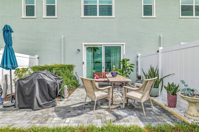 680 SE Lake Falls St, Port St Lucie, FL 34984 - fenced backyard with a patio area, area for grilling, and outdoor dining area