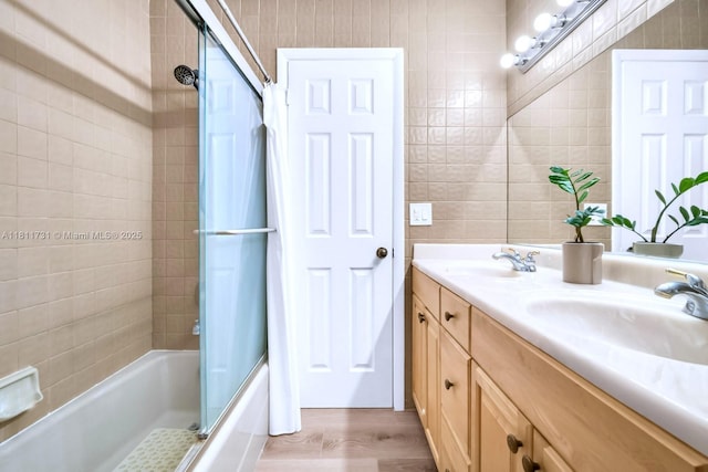 13711 SW 29th St, Davie, FL 33330 - full bath featuring double vanity, enclosed tub / shower combo, wood finished floors, and tile walls