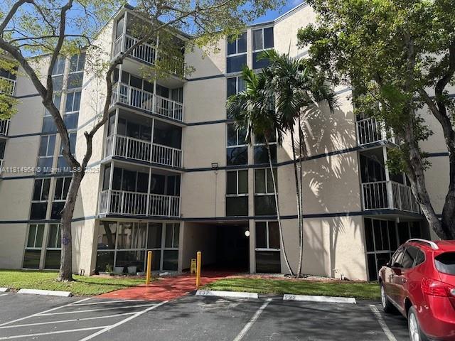 6955 NW 186th St Unit F301, Hialeah, FL 33015 - view of apartment building / complex with uncovered parking