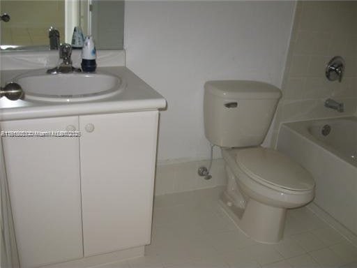 1666 SE 27th Ct Unit 205, Homestead, FL 33035 - full bathroom featuring vanity, toilet, tile patterned floors, and bathing tub / shower combination