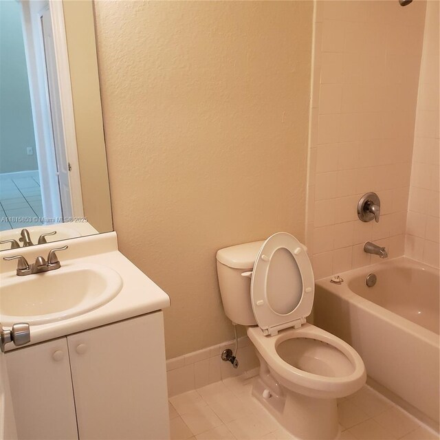 1666 SE 27th Ct Unit 205, Homestead, FL 33035 - bathroom with tile patterned floors, toilet, shower / tub combination, vanity, and a textured wall