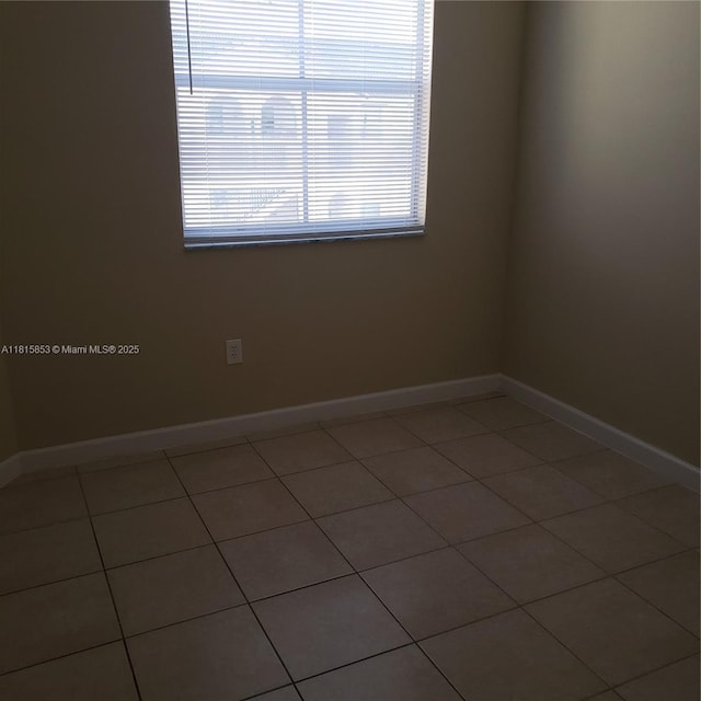 1666 SE 27th Ct Unit 205, Homestead, FL 33035 - tiled empty room featuring baseboards