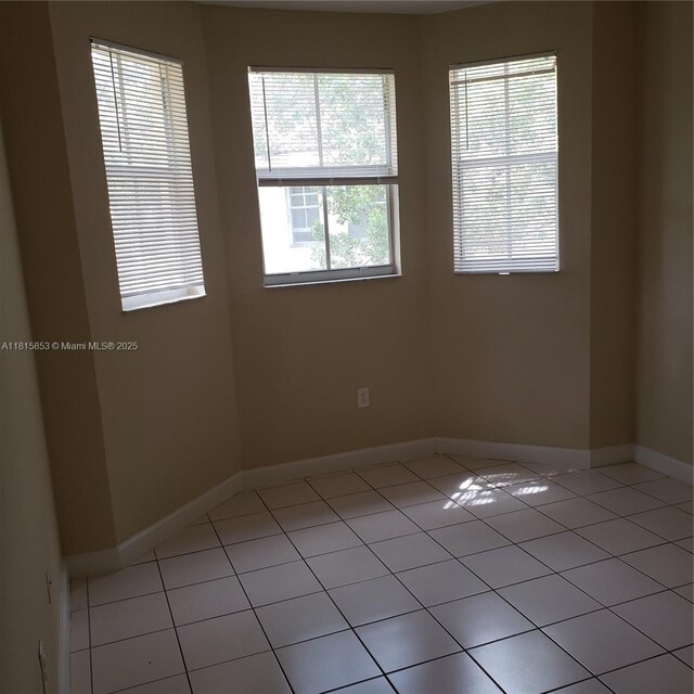 1666 SE 27th Ct Unit 205, Homestead, FL 33035 - unfurnished room with light tile patterned floors and baseboards