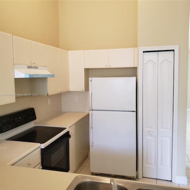 1666 SE 27th Ct Unit 205, Homestead, FL 33035 - kitchen with freestanding refrigerator, under cabinet range hood, electric stove, light countertops, and white cabinets