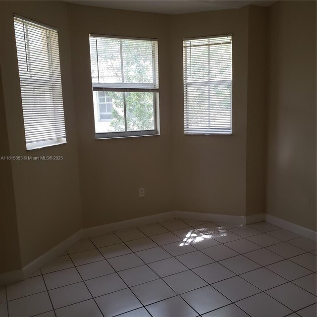 1666 SE 27th Ct Unit 205, Homestead, FL 33035 - empty room with light tile patterned flooring and baseboards