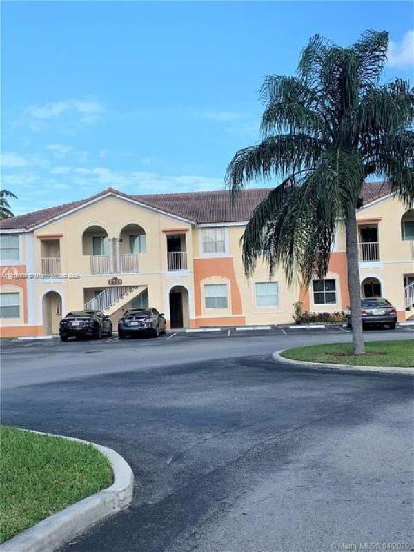 1666 SE 27th Ct Unit 205, Homestead, FL 33035 - view of building exterior featuring uncovered parking