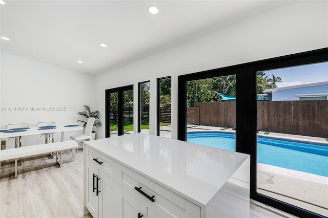 3105 SW 16th St, Fort Lauderdale, FL 33312 - kitchen with french doors, white cabinetry, light wood-style floors, recessed lighting, and light countertops
