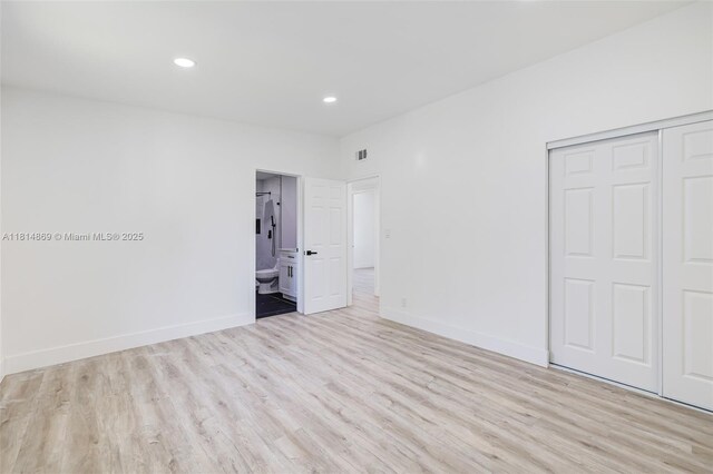 3105 SW 16th St, Fort Lauderdale, FL 33312 - unfurnished bedroom with wood finished floors, a closet, baseboards, recessed lighting, and connected bathroom