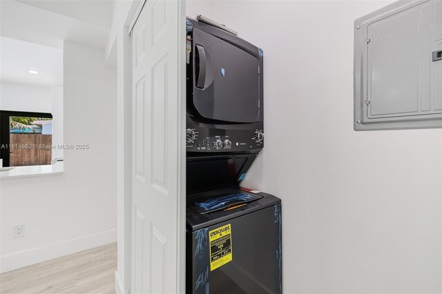 3105 SW 16th St, Fort Lauderdale, FL 33312 - laundry area with stacked washing machine and dryer, electric panel, wood finished floors, baseboards, and recessed lighting