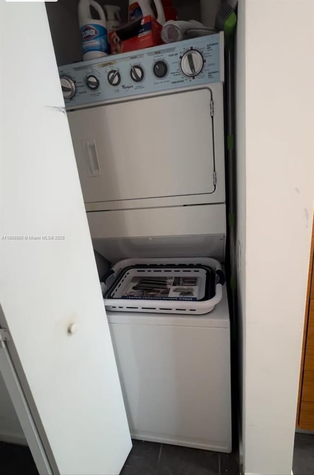 50 Biscayne Blvd Unit 3303, Miami, FL 33132 - laundry room with estacked washer and dryer and dark tile patterned flooring