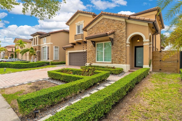 22618 SW 94th Path, Cutler Bay, FL 33190 - view of front of house featuring stone siding, stucco siding, driveway, a tiled roof, and an attached garage