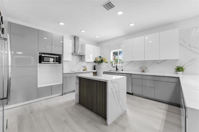 22618 SW 94th Path, Cutler Bay, FL 33190 - kitchen featuring modern cabinets, wall chimney range hood, stainless steel appliances, backsplash, and gray cabinets
